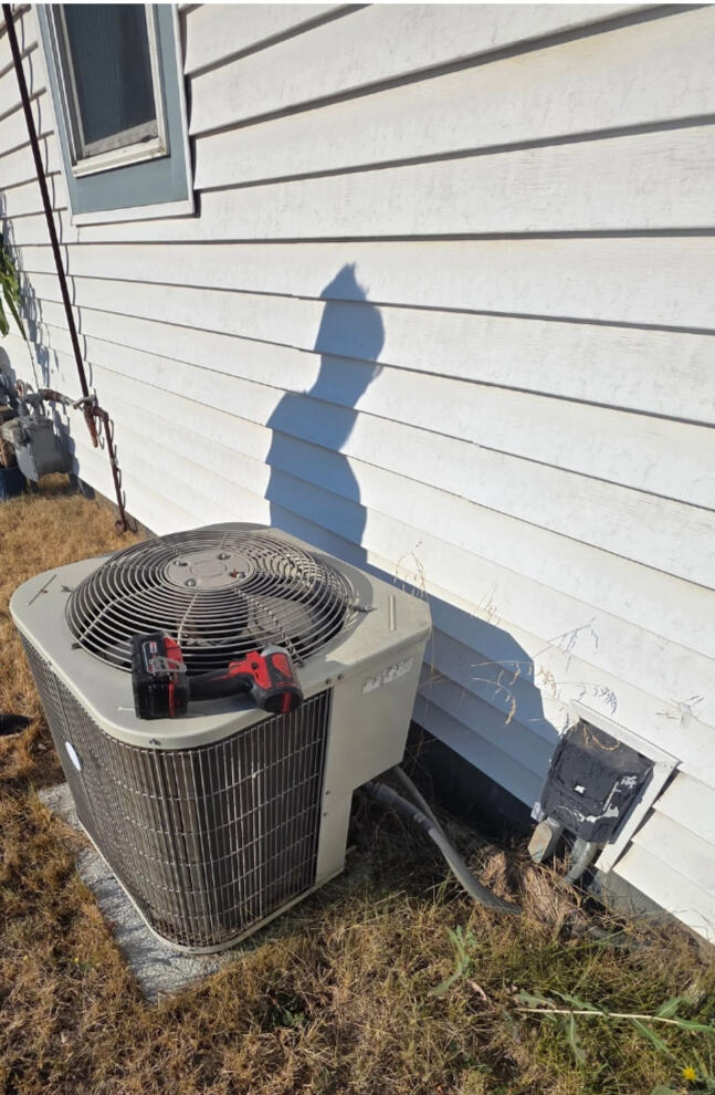 Servive technician servicing an air conditioner